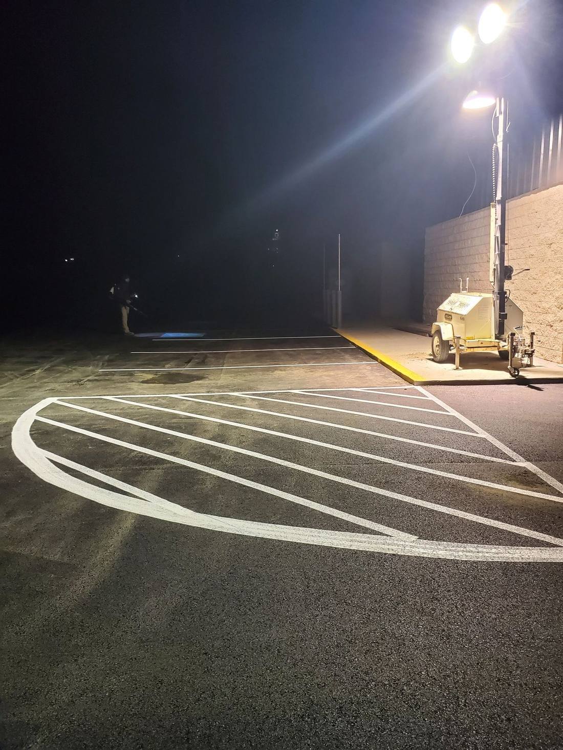 White hatch striping under a light tower at night