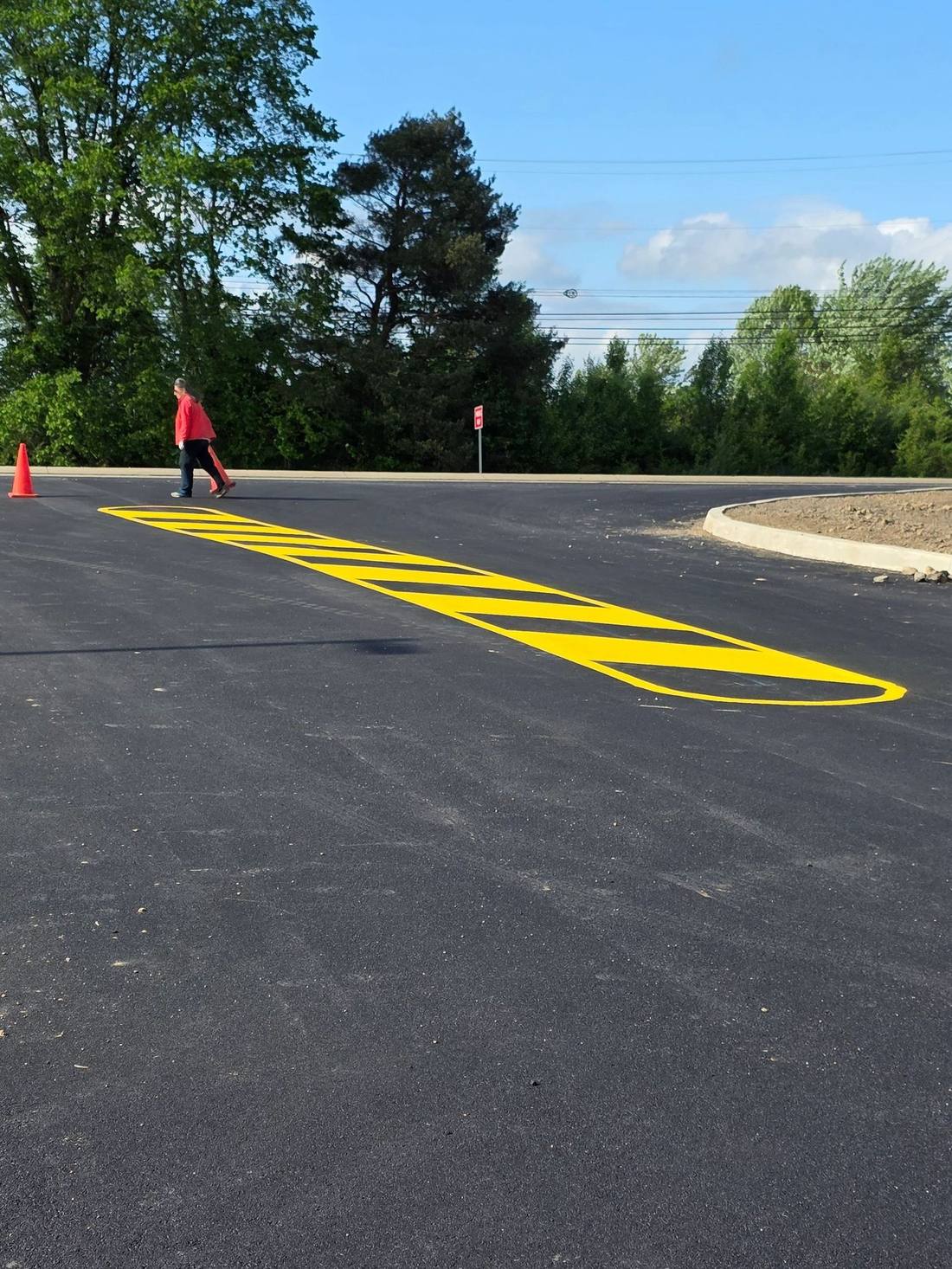 Yellow hatched safety marking on new asphalt