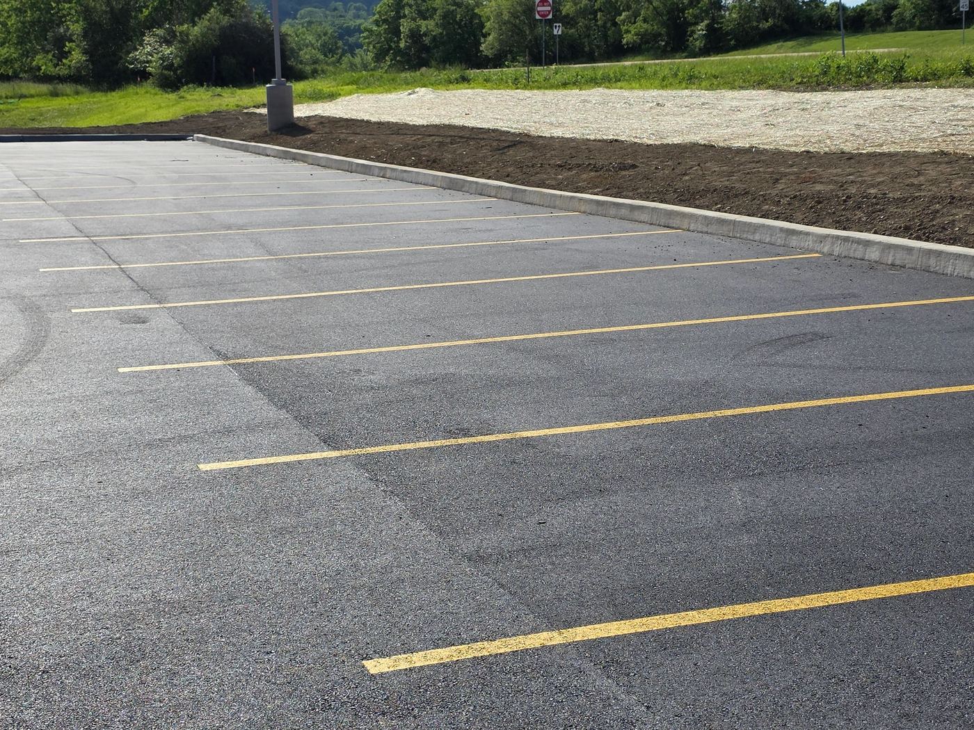 Fresh yellow stall lines on new asphalt